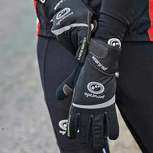 Cyclist wearing black waterproof winter gloves with white Optimum logo outdoors - Optimum