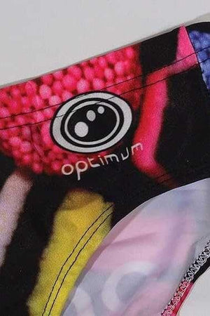 Optimum Tackle Trunks swim brief, close-up of hip with white Optimum logo on liquorice allsorts print - Optimum