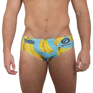 Optimum Tackle Trunks swim brief in banana print on blue, front view on male model with tackle trunks logo - Optimum