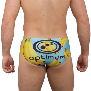 Optimum Tackle Trunks swim brief in banana print on blue, rear view on male model with black Optimum logo - Optimum