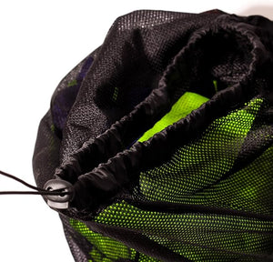 Close-up of open black mesh Optimum bib bag with green bibs inside and drawstring cord, on white - Optimum