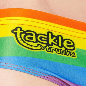 Optimum Tackle Trunks swim brief, close-up of tackle trunks logo on rainbow stripe waistband - Optimum
