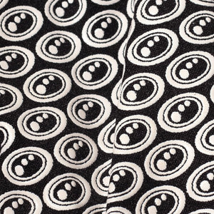 Extreme close-up of black Optimum Stik Mits glove fabric showing raised white oval silicone grip print - Optimum