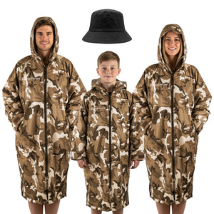 Three models in sand camo Optimum Dry Wrap robes, hoods up, black bucket hat, white background - Optimum