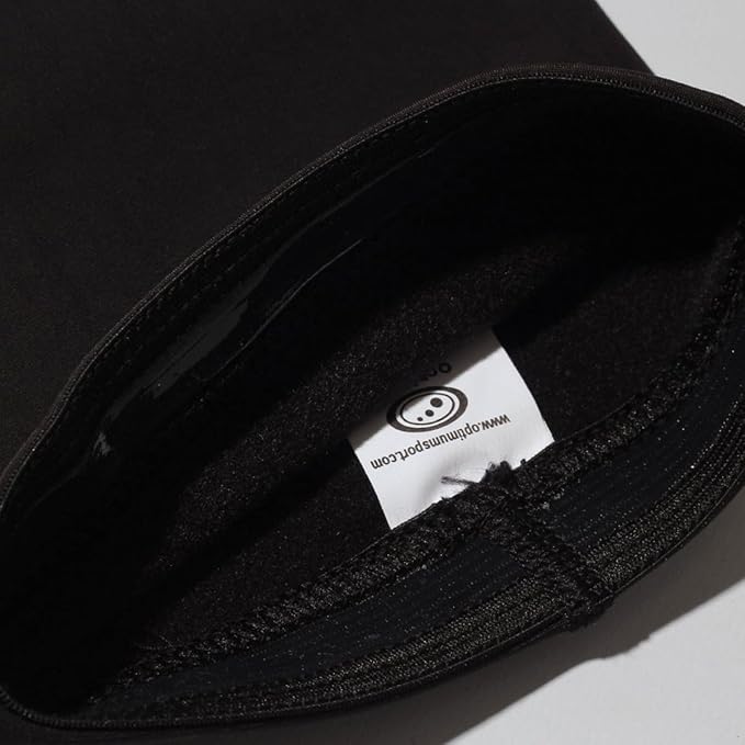 Close-up of black Optimum Hawkley arm warmer with white sewn-in branded care label - Optimum