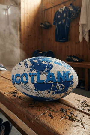 White and blue Optimum Scotland rugby ball with SCOTLAND print on a bench in a changing room - Optimum