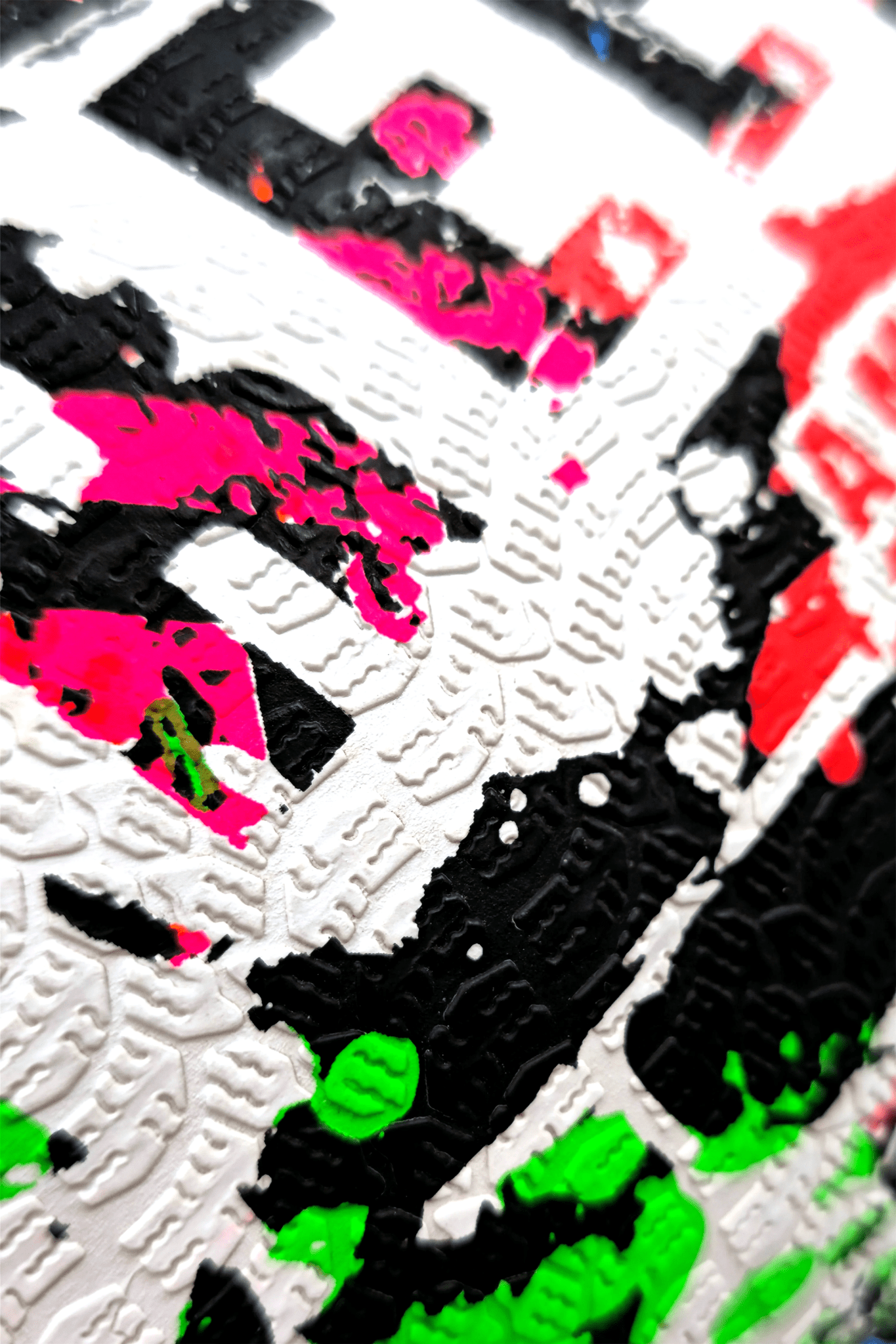 Macro close-up of graffiti paint-splatter surface on Optimum Street football - Optimum