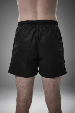 Man wearing black Optimum Auckland rugby shorts, back view on grey studio background - Optimum