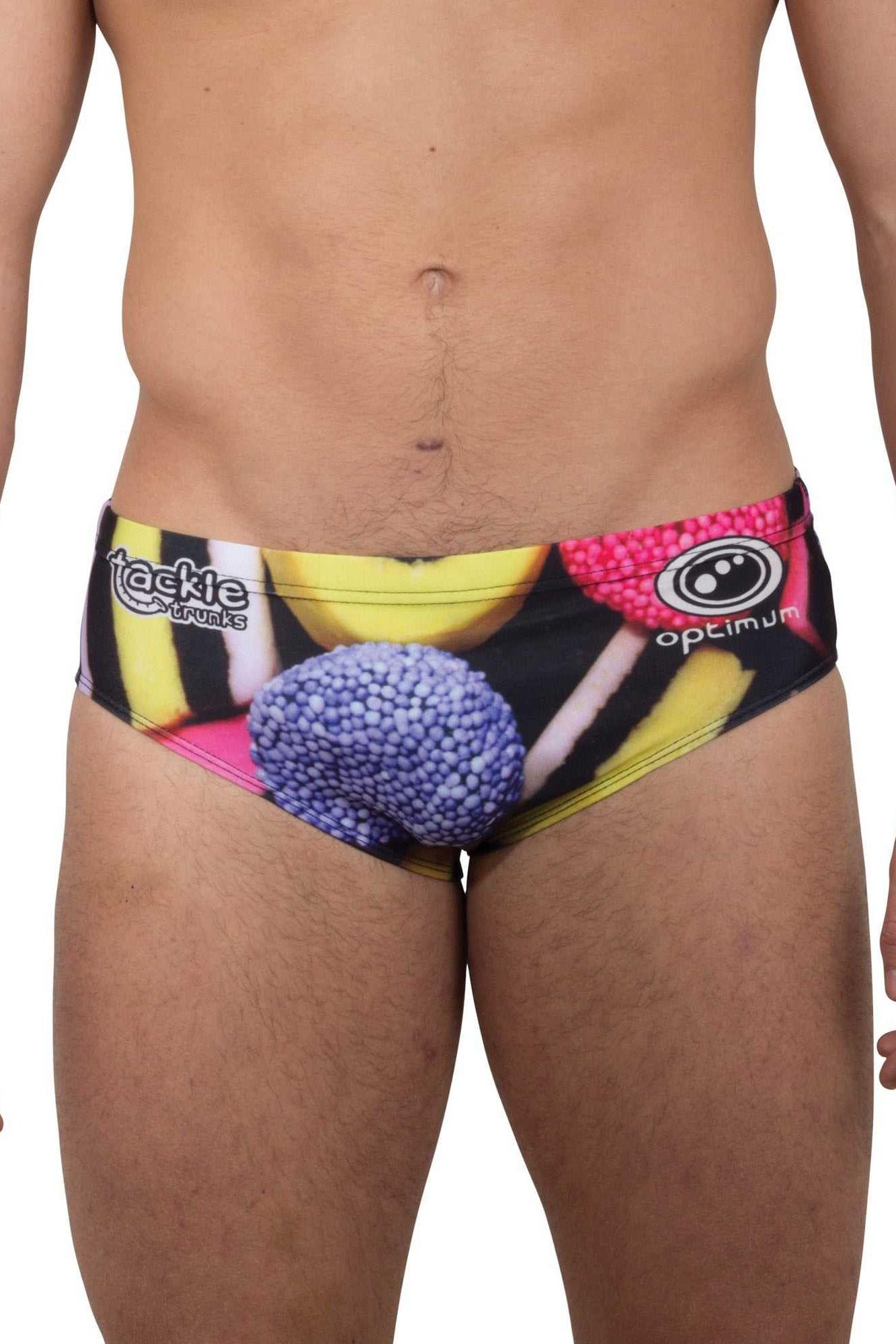 Optimum Tackle Trunks swim brief in liquorice allsorts print, front view on male model with tackle trunks logo - Optimum