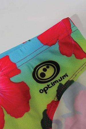 Optimum Tackle Trunks swim brief, close-up of hip with black Optimum logo on neon hibiscus floral print - Optimum