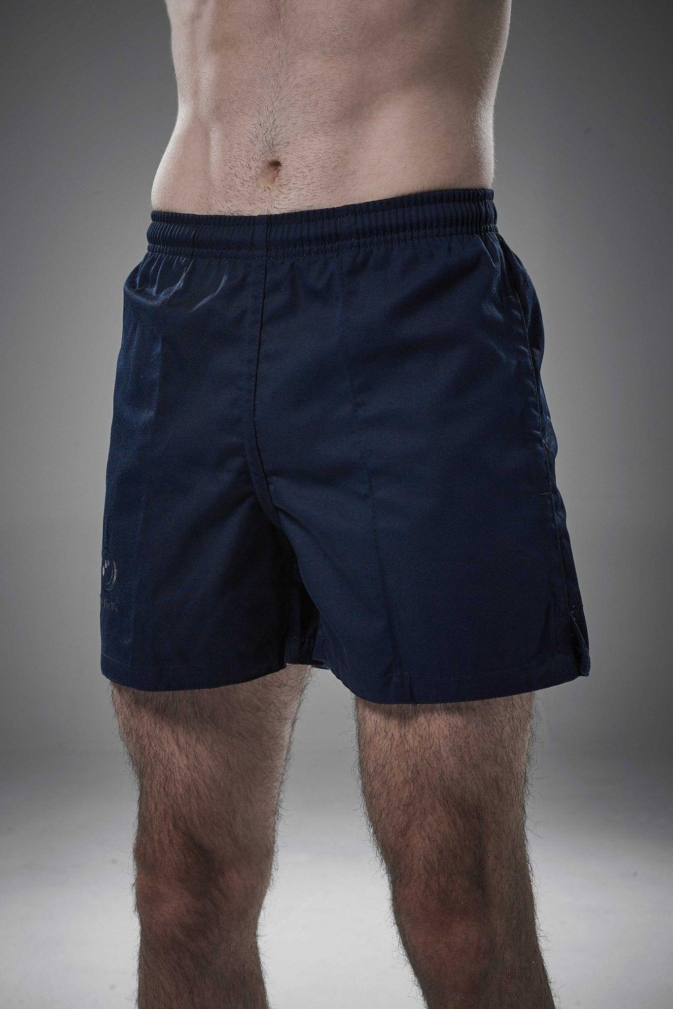 Man wearing navy Optimum Auckland rugby shorts, front view on grey studio background - Optimum