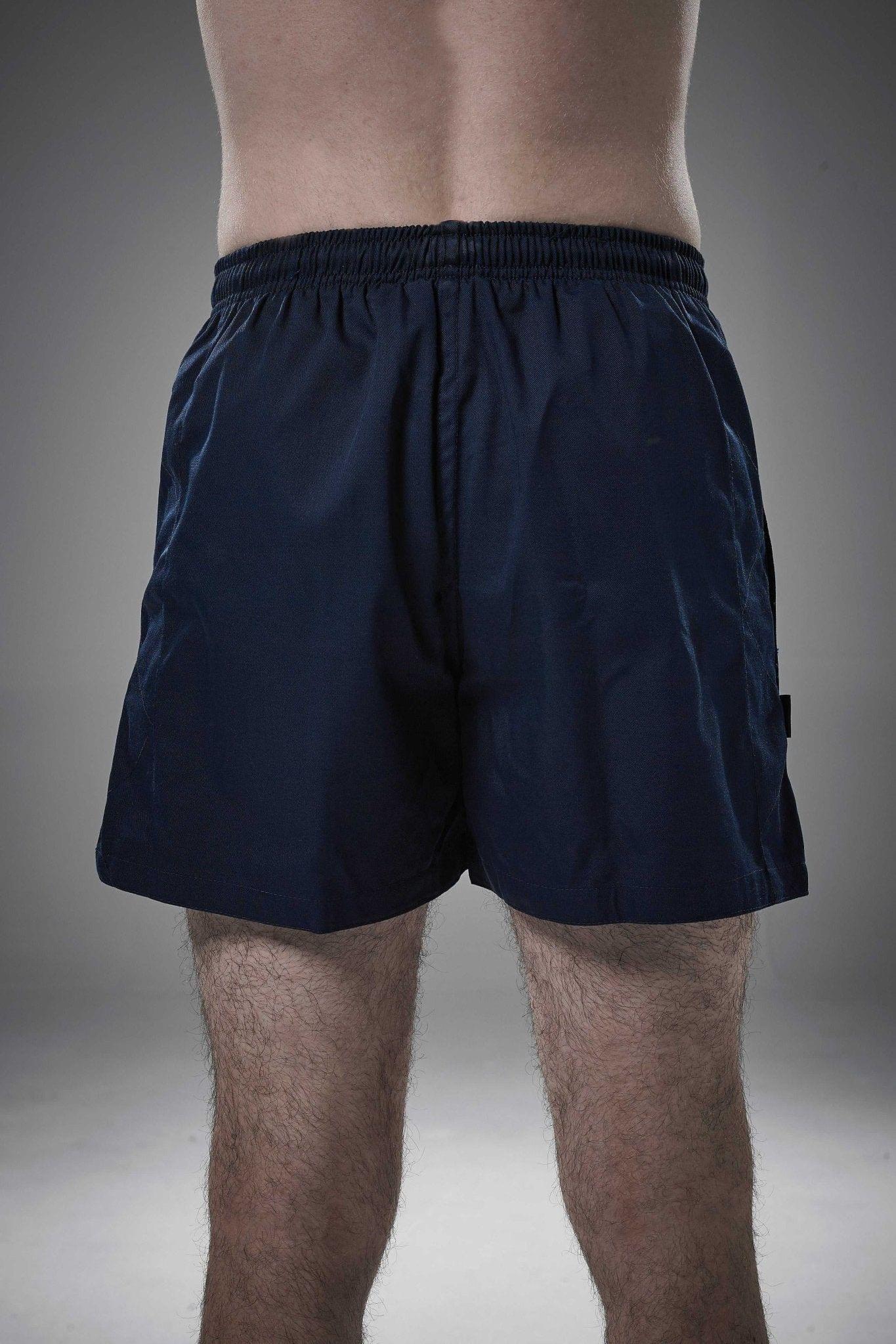 Man wearing navy Optimum Auckland rugby shorts, back view on grey studio background - Optimum