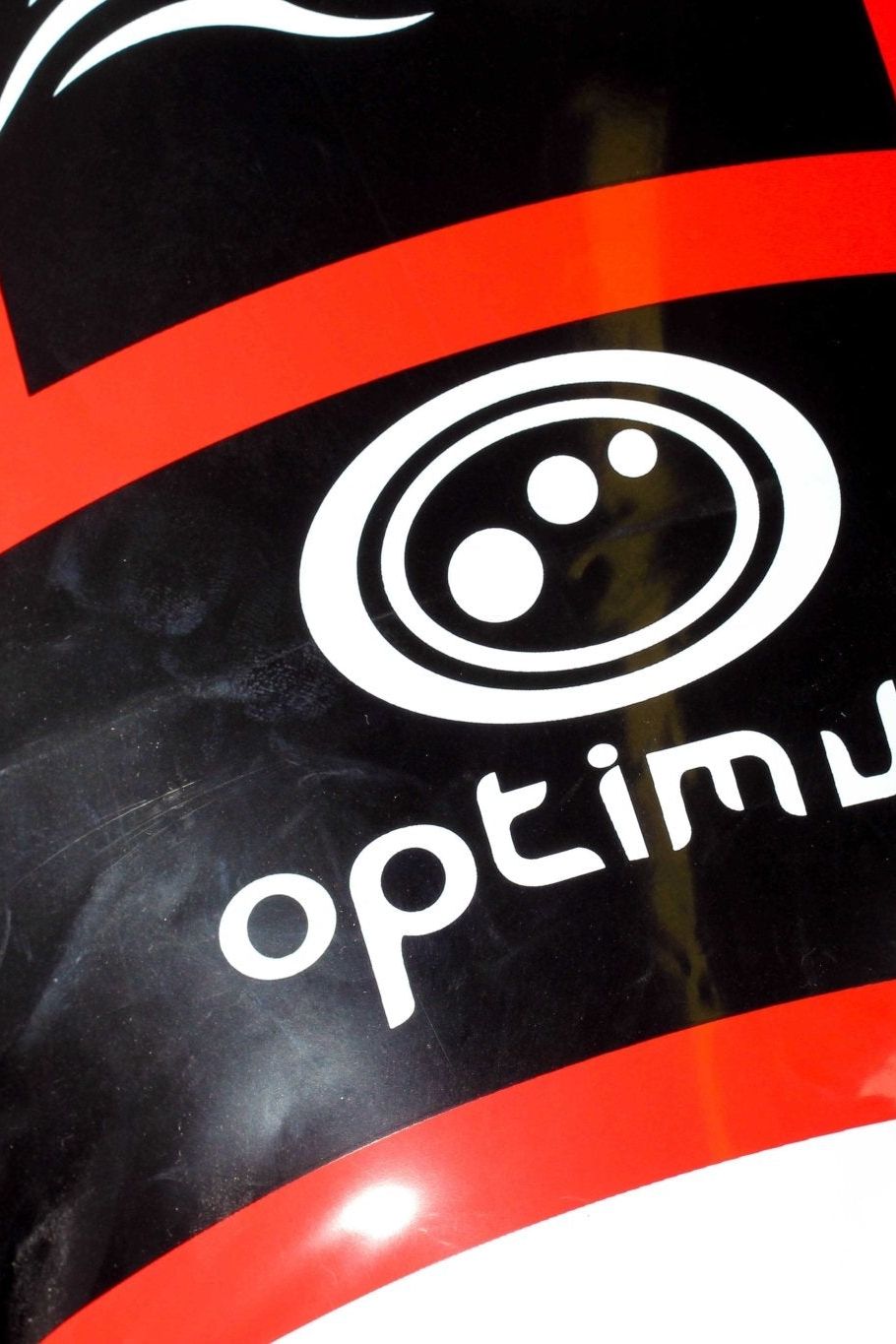Close-up of red and black Optimum inflatable tackle buddy showing white logo print on black - Optimum