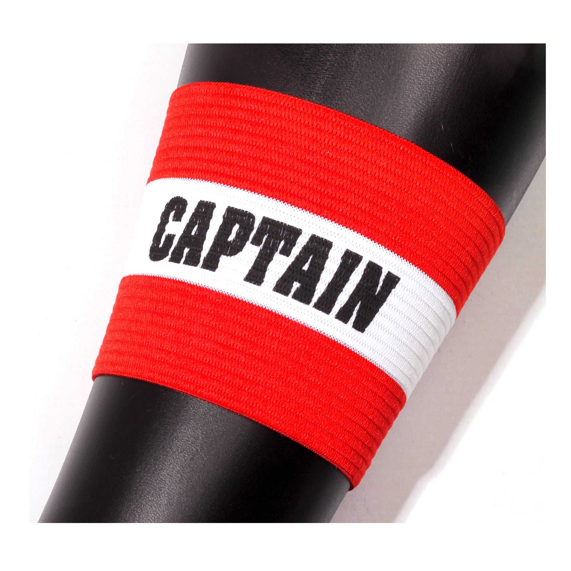 Red Optimum captain's armband with white stripe reading CAPTAIN wrapped around a black post - Optimum