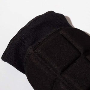 Close-up of black Optimum elbow guard showing ribbed cuff and padded panels - Optimum