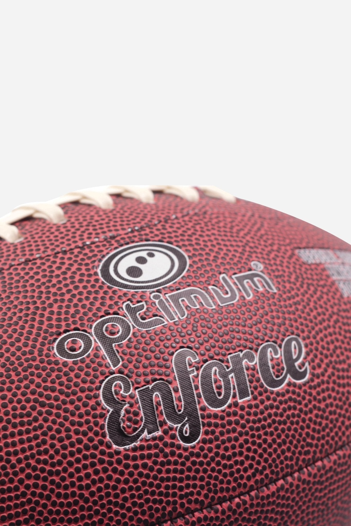 Close-up of maroon Optimum Enforce American football showing logo and pebbled grain - Optimum