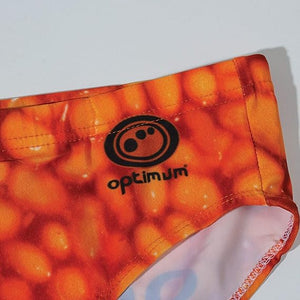 Optimum Tackle Trunks swim brief, close-up of hip with black Optimum logo on orange baked beans print - Optimum