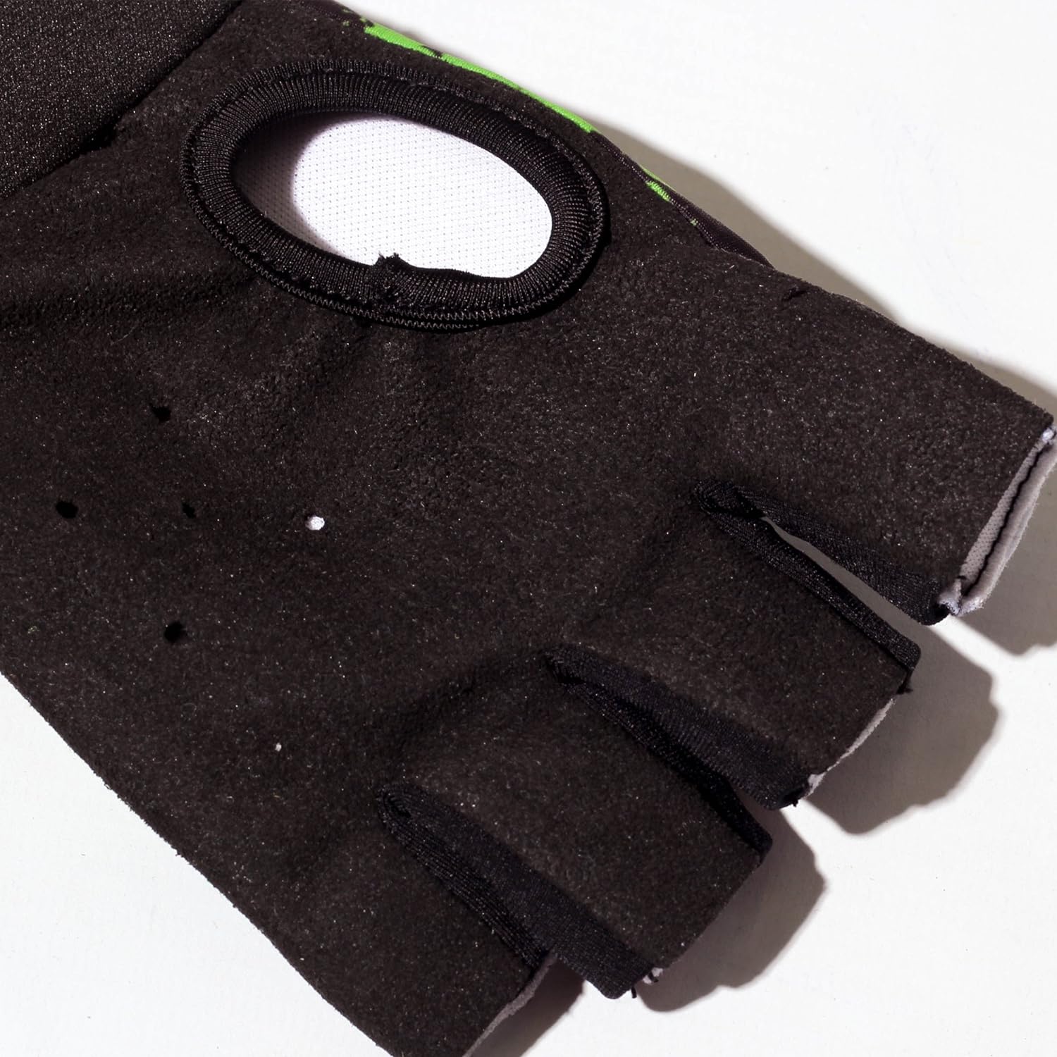 Close-up of black Optimum Fusion half-finger hockey glove palm with ventilation opening and holes, on white - Optimum