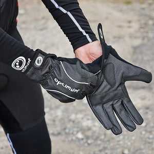 Person wearing black winter cycling gloves outdoors on gravel, adjusting the fit - Optimum