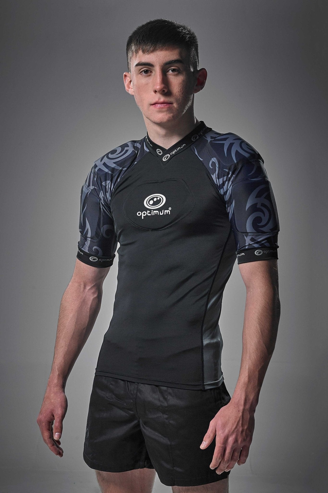 Black Optimum Razor protective top with grey tribal-print padded shoulders, front view on model - Optimum