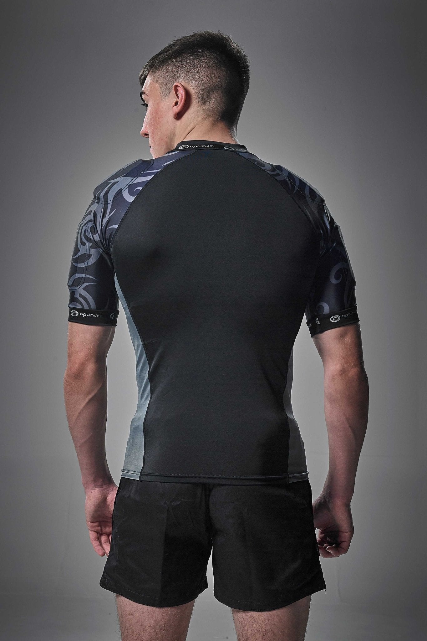 Black Optimum Razor protective top with grey tribal-print padded shoulders, rear view on model - Optimum