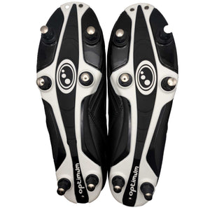 Underside of black and white Optimum Razor football boots showing six screw-in studs, on white - Optimum