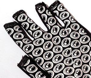 Close-up of black Optimum Stik Mits fingerless glove palm with all-over white oval grip print on white - Optimum