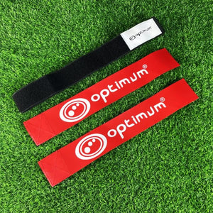 Black Optimum tag rugby belt with velcro tab and two red flags with white logo, on grass