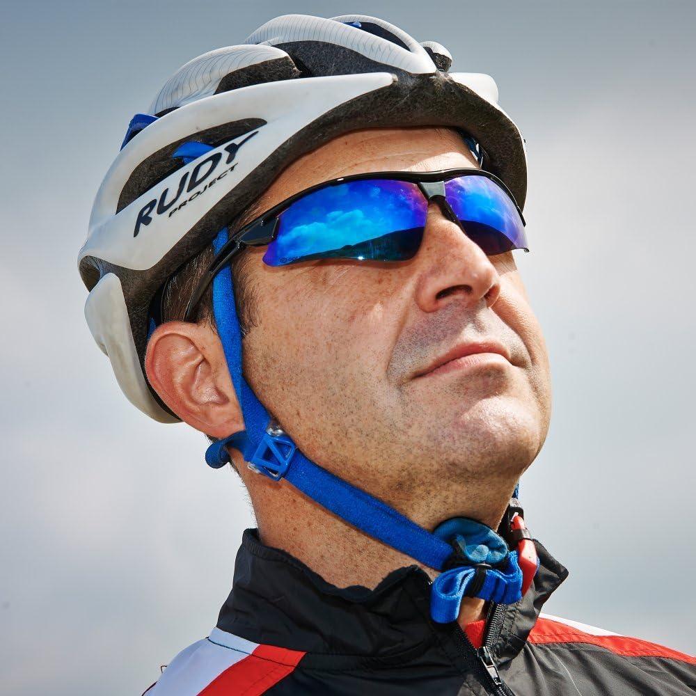 Cyclist in white helmet wearing Optimum sunglasses with blue mirrored lenses against sky, lifestyle shot - Optimum